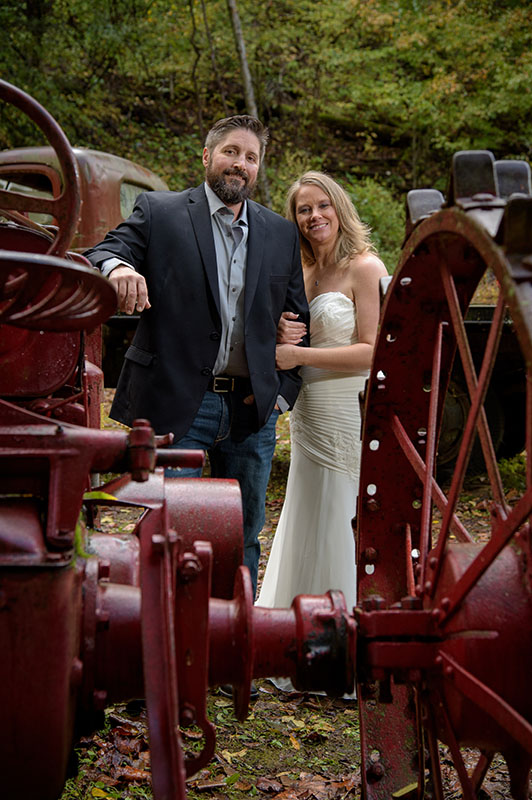 bride and groom with antique tractor